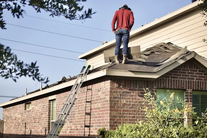 Professional roofer working on a residential roof in Venus